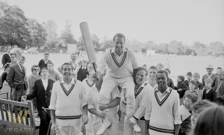 Basil D’Oliveira being lifted on teammates’ shoulders, holding his bat, after a memorable cricket match