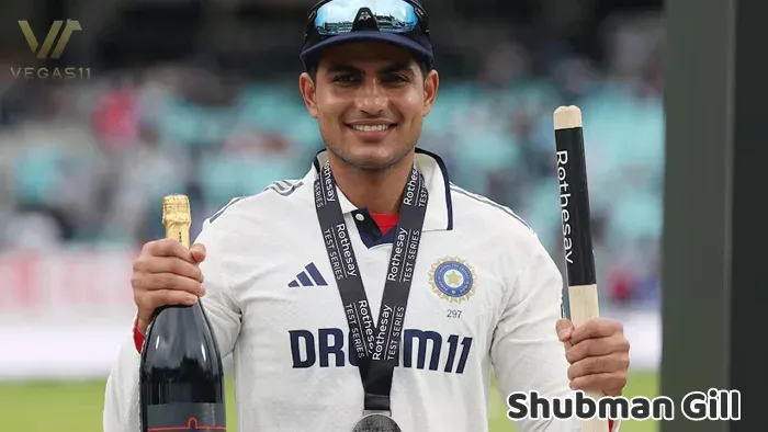 New Captain Shubman Gill holding his bat and a champagne bottle on the field.